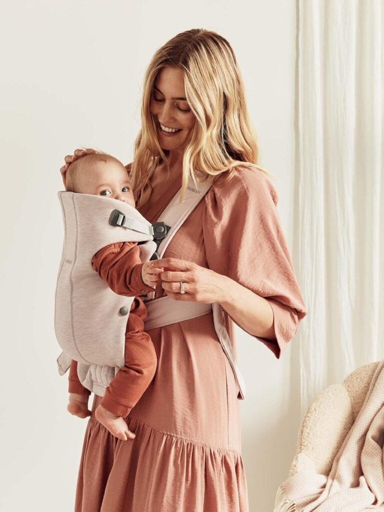 Baby resting comfortably in BabyBjörn Mini Carrier for newborns up to 25 lbs