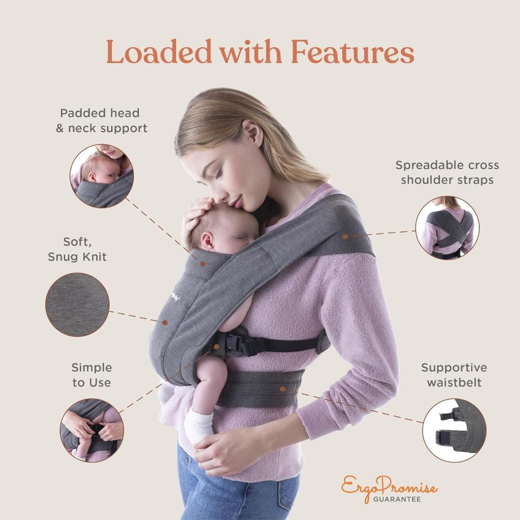Parent wearing newborn in Ergobaby Embrace carrier, breathable cream fabric