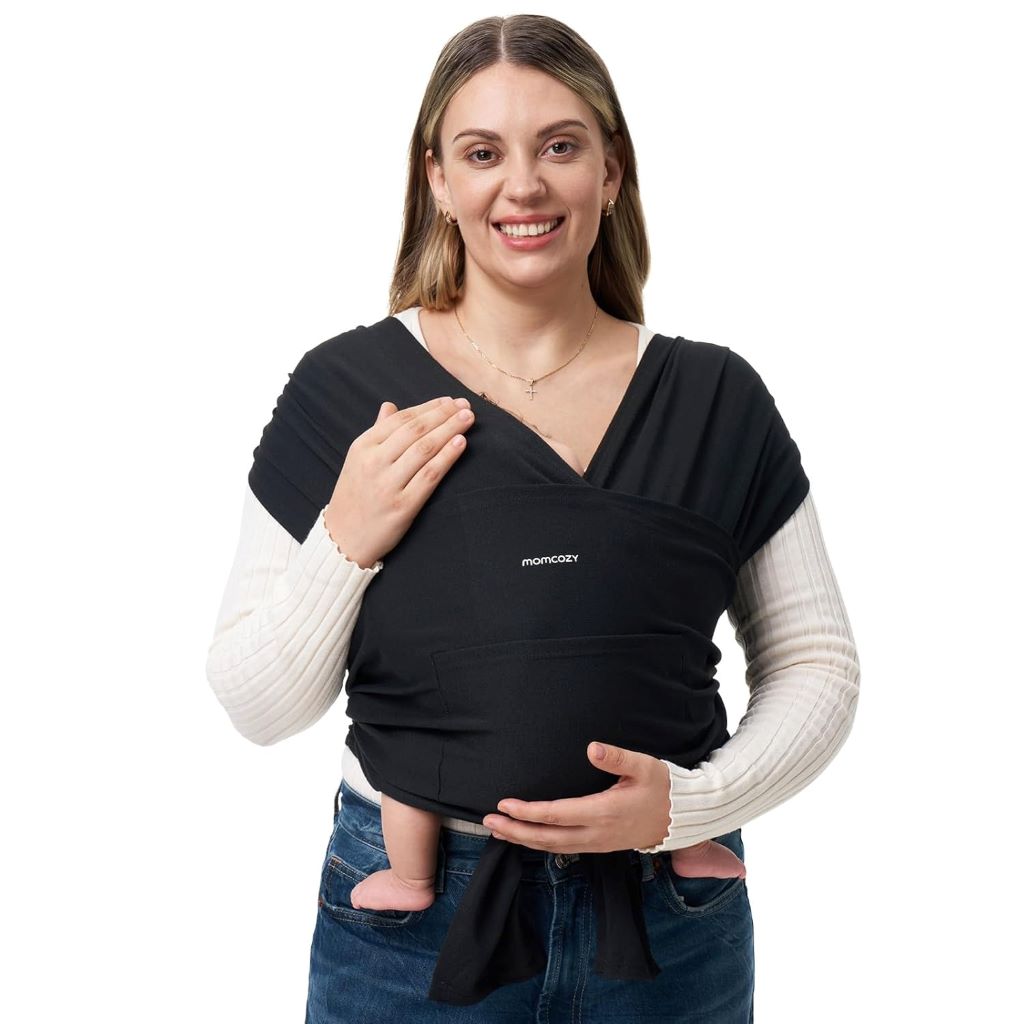Parent wearing a black Momcozy baby wrap carrier holding a newborn securely.