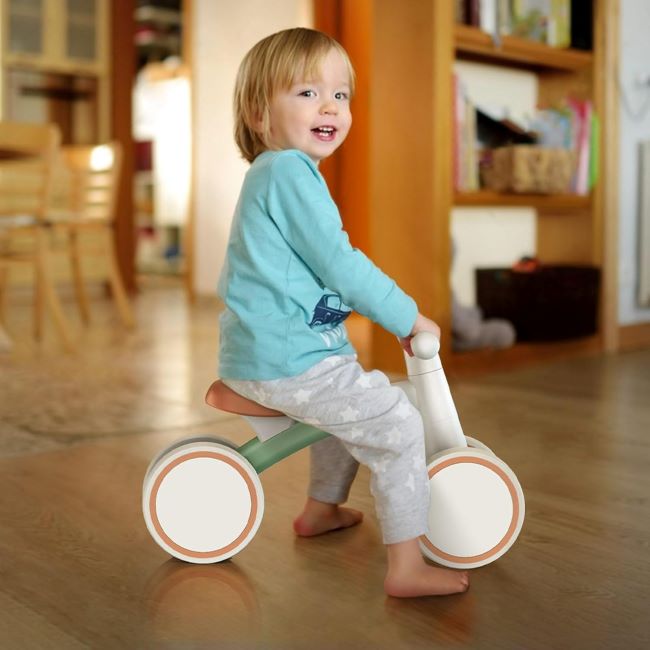12-24 month toddler enjoying SEREED 4-wheel balance bike for first ride.