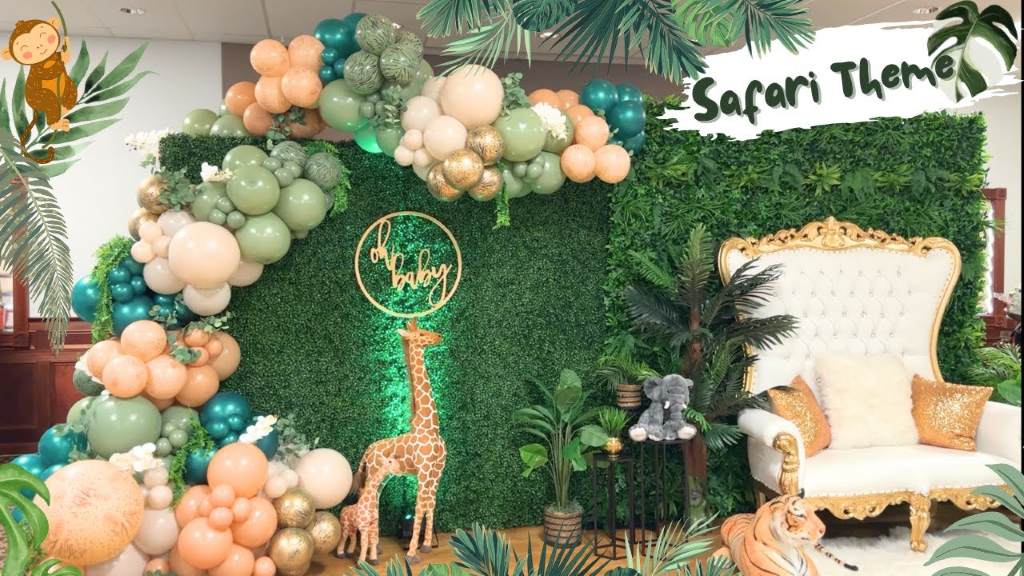 Stunning safari theme baby shower featuring forest friends plush animals and green balloon arch