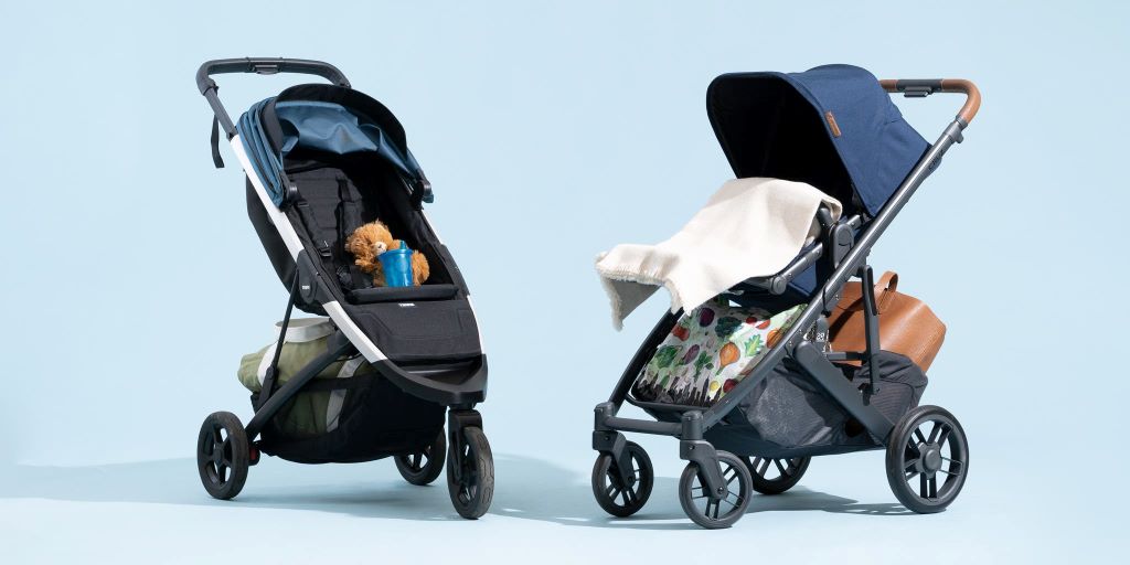 Parent pushing a safe and comfortable baby stroller on a sidewalk for everyday travel