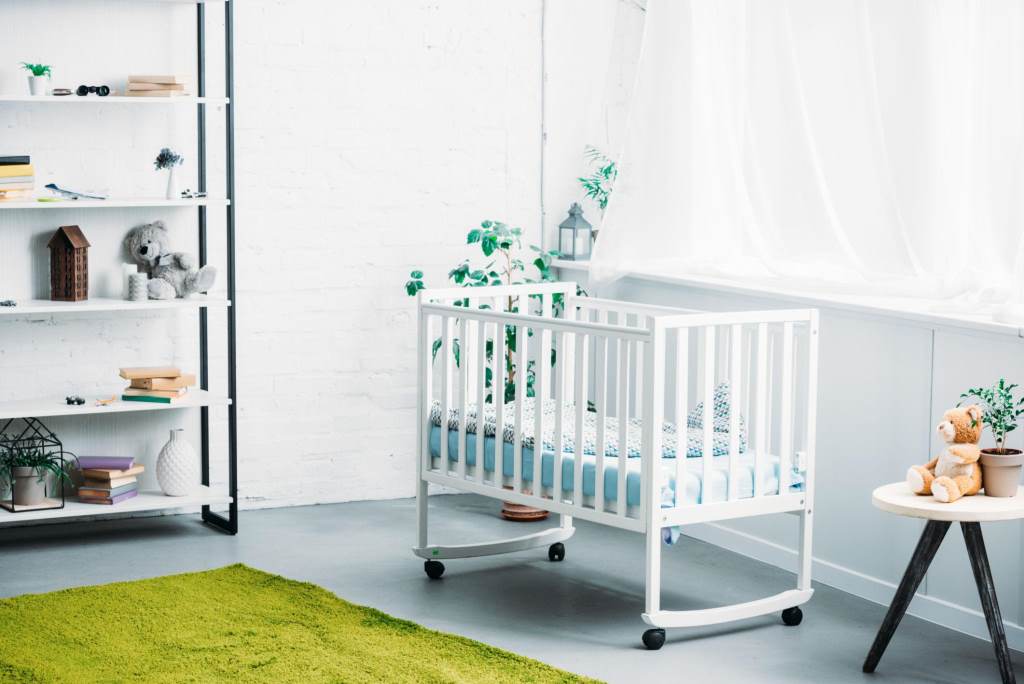 interior of modern light childrens room with crib