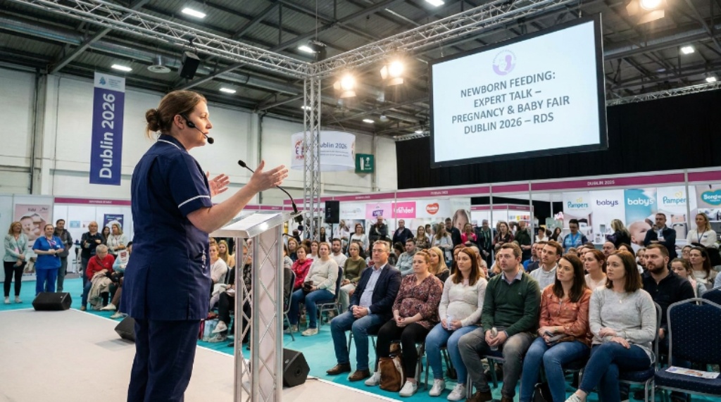 A midwife delivering an expert talk on newborn feeding to an audience of expectant parents on the main stage at the Pregnancy and Baby Fair Dublin 2026 at the RDS